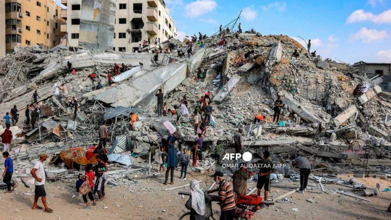 People search for salvage at the mound of rubble at the site of the collapsed Sussi Tower, which was destroyed earlier by Israeli bombardment, in Gaza City on September 6, 2025. - AFP