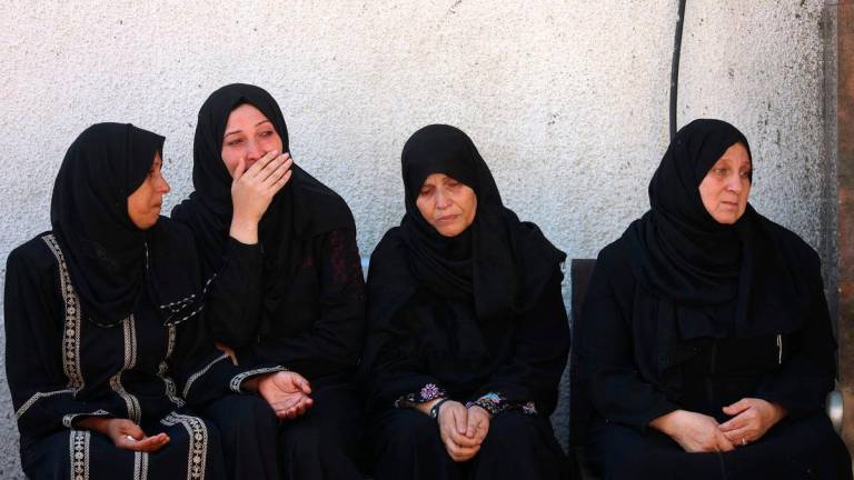 Palestinian women mourn relatives, killed in an Israeli strike, outside the al-Shifa hospital in Gaza City on July 7, 2025. (Photo by Omar AL-QATTAA / AFP)