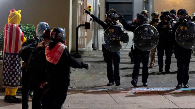 Law enforcement officers disperse protesters outside the ICE (Immigration and Customs Enforcement) headquarters in South Portland, Oregon, U.S., October 2, 2025. - REUTERSPIX