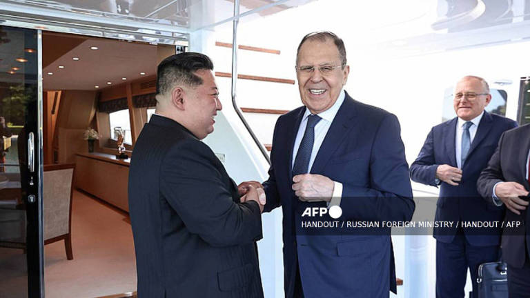 This handout photograph released by the Russian Foreign Ministry shows Russian Foreign Minister Sergei Lavrov (C) shaking hands with North Korean leader Kim Jong Un (L) in Wonsan on July 12, 2025. Russian Foreign Minister Lavrov on July 12, 2025 met with North Korean leader Kim Jong Un during his visit to the secretive country and key Moscow ally, Russia’s foreign ministry said. (Photo by Handout / RUSSIAN FOREIGN MINISTRY / HANDOUT) - AFP
