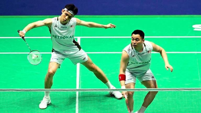 Malaysia’s Aaron Chia and Wooi Yik Soh return the shuttlecock as they play against India’s Satwiksairaj Rankireddy and Chirag Shetty in the men’s double quarter-final match at the Badminton BWF World Championships at the Adidas Arena in Paris, on August 29, 2025. (Photo by Bertrand GUAY / AFP)