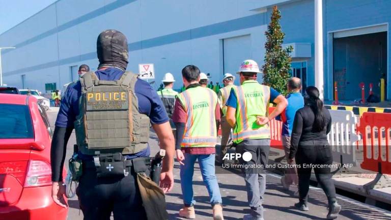 This handout photo released by US Immigration and Customs Enforcement (ICE) on September 5, 2025 allegedly shows a Homeland Security Investigations police officer during a federal search warrant at a company in Ellabell, Georgia, on September 4, 2025. - Handout by US Immigration and Customs Enforcement / AFP