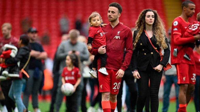 (FILES) Liverpool’s Portuguese striker Diogo Jota celebrates his family during a lap of honour at the end of the English Premier League football match between Liverpool and Wolverhampton Wanderers at Anfield in Liverpool, north west England on May 22, 2022-AFP