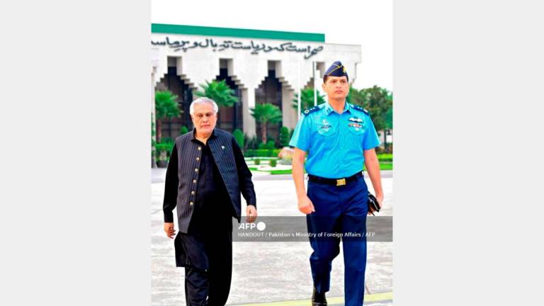 In this handout photograph taken and released by Pakistan’s Ministry of Foreign Affairs on August 23, 2025, Pakistan’s Foreign Minister Ishaq Dar (L) departs for Bangladesh, from Islamabad. Pakistan’s foreign minister flew to Bangladesh on August 23 as the nations, once bitter enemies after they split in 1971, seek to rebuild ties with regional power balances shifting. - HANDOUT / Pakistan’s Ministry of Foreign Affairs / AFP