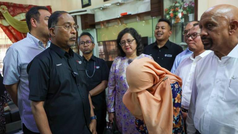 Minister of Higher Education Datuk Seri Dr Zambry Abd Kadir (second left) engages in a friendly conversation with Ummu Haiman Bee Daulatgum (second right) during a visit to the family of Syamsul Haris Shamsudin, who passed away while undergoing Palapes training at Universiti Teknologi Mara (UTM) in Taman Pelangi Semenyeh today. - BERNAMA