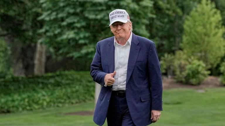 FILE PHOTO: U.S. President Donald Trump gives a thumbs up as he walks on the South Lawn of the White House in Washington, D.C., U.S., May 25, 2025. REUTERSpix