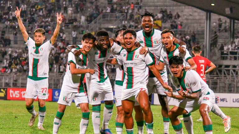 The action of Kuching City FC players after scoring a goal in the final minutes of the FA Cup match at the State Stadium last night. - BERNAMA