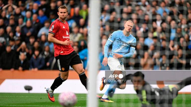 Manchester City's Norwegian striker #09 Erling Haaland (C) shoots but misses the target in the first moments of the English Premier League football match between Manchester City and Manchester United at the Etihad Stadium in Manchester, north west England, on September 14, 2025. - AFP
