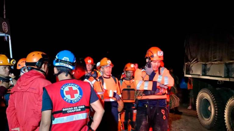 This handout photo taken on February 6, 2024 and released on February 7 by the Philippine Red Cross - Davao de Oro Chapter shows personnel arriving for search and rescue operations following a landslide in Maco municipality in Davao de Oro province/AFPPix