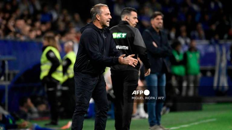 Barcelona's German coach Hans-Dieter Flick gestures to players during the Spanish league football match between Real Oviedo and FC Barcelona at the Carlos Tartiere stadium in Oviedo on September 25, 2025. - AFP