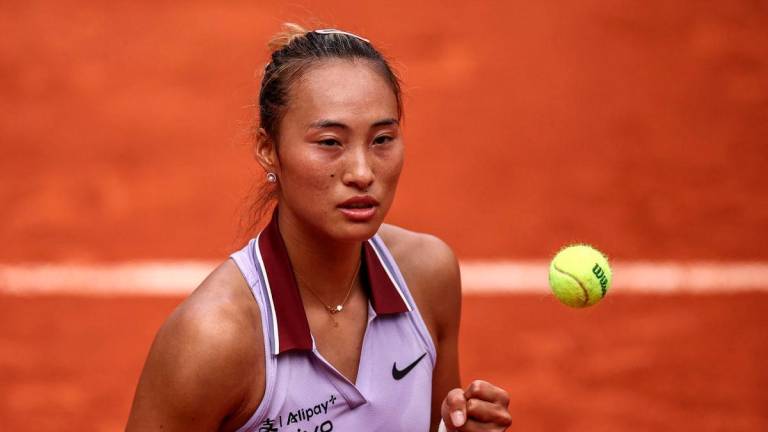 China’s Zheng Qinwen reacts after a point during her women’s singles match against Russia’s Liudmila Samsonova on day 8 of the French Open tennis tournament on Court Suzanne-Lenglen at the Roland-Garros Complex in Paris on June 1, 2025. (Photo by Anne-Christine POUJOULAT / AFP)