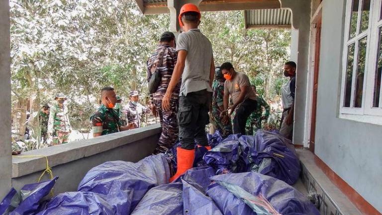 Members of a rescue team carry away body bags containing deceased people at Klatanlo village, in East Flores Regency, East Nusa Tenggara - AFPpix