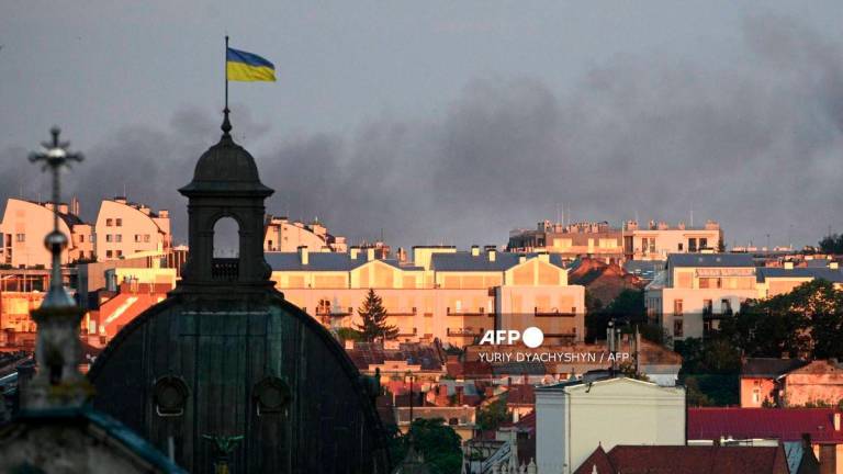 Smoke billows above the city's buildings following mass Russian drone and missile strikes in the western Ukrainian city of Lviv on July 12, 2025, amid the Russian invasion of Ukraine. - AFP