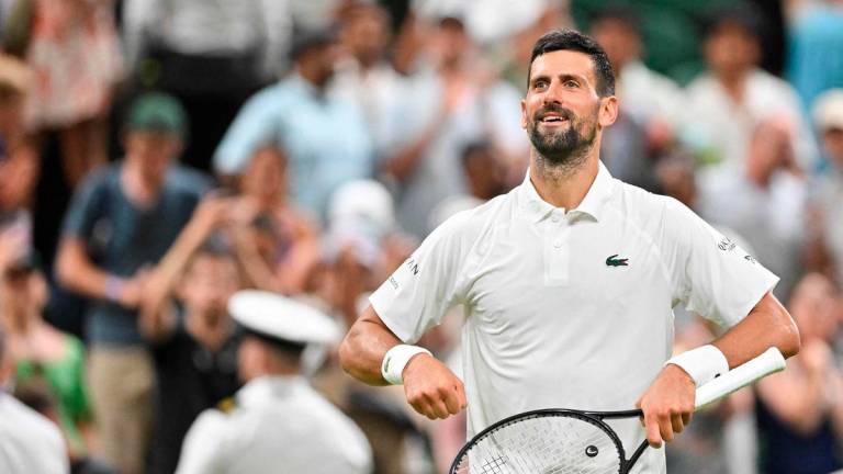 Serbia’s Novak Djokovic celebrates winning against France’s Alexandre Muller at the end of their men’s singles first round tennis match on the second day of the 2025 Wimbledon Championships at The All England Lawn Tennis and Croquet Club in Wimbledon, southwest London, on July 1, 2025- AFP