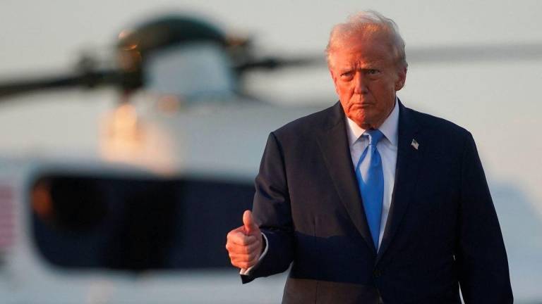 U.S. President Donald Trump walks with Marine One in the background, as he departs for New York City to attend the 80th United Nations General Assembly, at Joint Base Andrews, Maryland, U.S., September 22, 2025. - REUTERSPIX