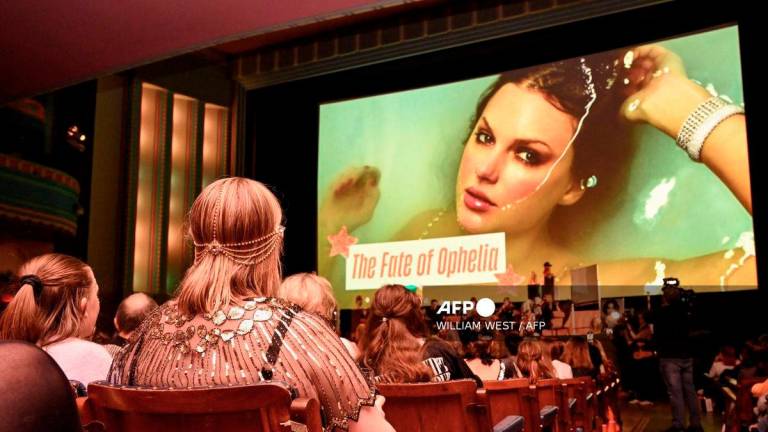 Taylor Swift fans listen to a song during a listening event for Swift's new album 'The Life of a Showgirl' at the Astor Theatre in Melbourne on October 3, 2025. - AFP