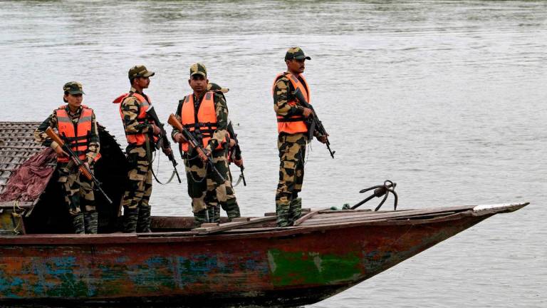 Border Security Force (BSF) personnel riding a boat patrol along the Gangadhar river near the India-Bangladesh border in Golakganj, Dhubri district in India’s Assam State on May 26, 2025. - AFPPIX