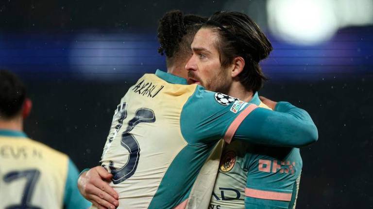 Manchester City's English midfielder #10 Jack Grealish is congratulated by teammates after scoring a goal during the UEFA Champions League, league phase football match between Paris Saint-Germain and Manchester City at the Parc des Princes Stadium in Paris on January 22, 2025. - AFPPIX