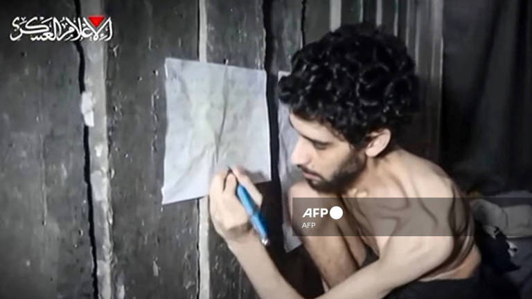 This screengrab from a video released on August 1, 2025 by the armed wing of Palestinian militant group Hamas, shows Israeli hostage Evyatar David looking weak and malnourished. David, who turned 24 in captivity, was abducted during the Hamas attack on October 7, 2023. - AFP