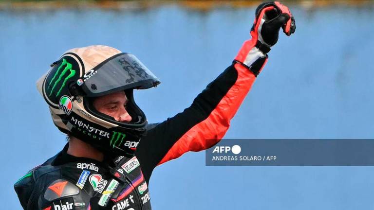 Aprilia Racing team's Italian MotoGP rider Marco Bezzecchi celebrates winning the San Marino Moto GP Sprint Race at the Misano World Circuit Marco Simoncelli, in Misano Adriatico, northern Italy, on September 13, 2025. - AFP