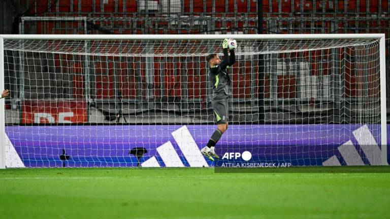 Italy's goalkeeper #01 Gianluigi Donnarumma jumps to catch the ball during the 2026 World Cup qualifiers Europe zone group I football match between Israel and Italy on September 8, 2025 in Debrecen, Hungary. - AFPPIX