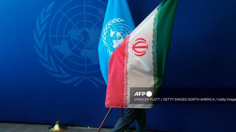 The Iranian flag is taken out of the room after Iranian President Masoud Pezeshkian met with the United Nations (UN) Secretary General Antonio Guterres during the UN's General Assembly on September 25, 2025, in New York City. - AFP