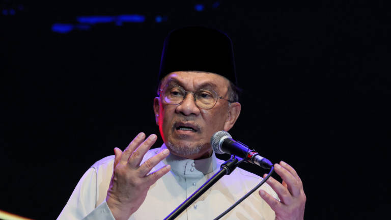 Prime Minister Datuk Seri Anwar Ibrahim delivers a speech at the launch of the *Rancakkan MADANI Kelantan State Programme* and the rollout of the *Aku Kasih Malaysia* Programme at the USM Health Campus in Kubang Kerian, today. – BERNAMA