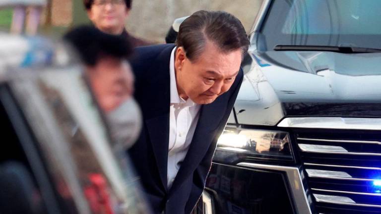 South Korean impeached President Yoon Suk Yeol bows outside the Seoul detention center after his release, in Uiwang, South Korea, March 8, 2025. REUTERS/Kim Hong-ji