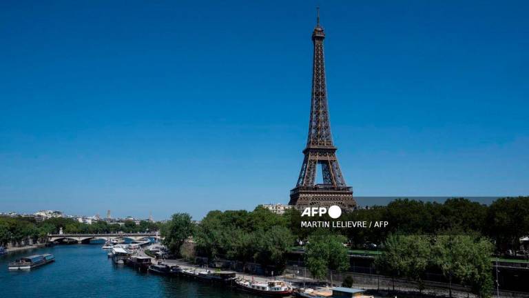 This photograph shows a view the Eiffel tower and the Seine river in Paris on August 11, 2025, amid a heatwavein Europe. - AFP