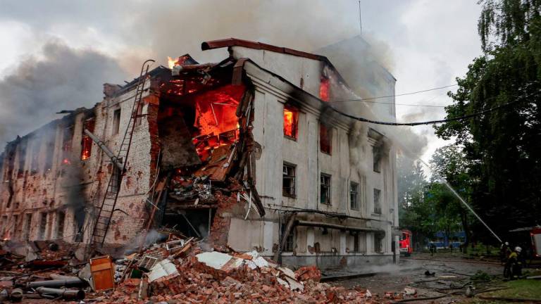Firefighters work at the site of a building hit by a Russian drone strike, amid Russia's attack on Ukraine, in Kharkiv, Ukraine June 7, 2025. - REUTERSPIX
