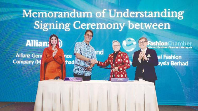 From left: Leena, Allianz General deputy chief sales officer Sazali Abd Rahman, Jay, and Malaysia External Trade Development Corporation deputy CEO Abu Bakar Yusof at the MoU signing ceremony.