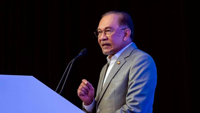 Prime Minister Datuk Seri Anwar Ibrahim delivers his keynote address at the Sasana Symposium 2025 here today. - BERNAMAPIX