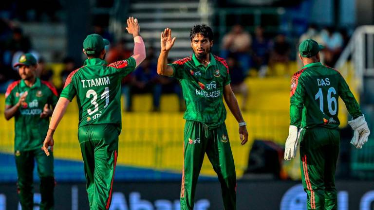 Bangladesh’s Tanzim Hasan Sakib (C) celebrates with teammates after taking the wicket of Sri Lanka’s Milan Rathnayake during the first one-day international (ODI) cricket match between Sri Lanka and Bangladesh at the R. Premadasa International Cricket Stadium in Colombo on July 2, 2025. (Photo by Ishara S. KODIKARA / AFP)
