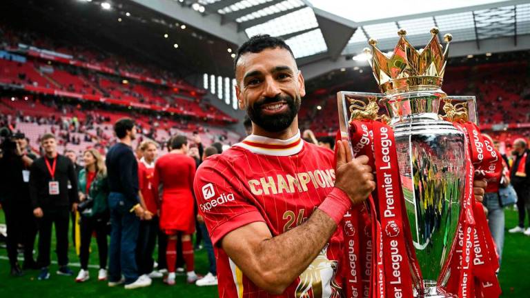 Liverpool’s Egyptian striker #11 Mohamed Salah celebrates with the Premier League trophy at the end of the English Premier League football match between Liverpool and Crystal Palace at Anfield in Liverpool, north west England on May 25, 2025. AFP