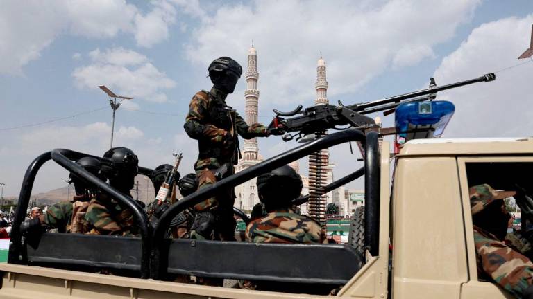 Houthi police officers patrol on a vehicle the site of a rally held by protesters, predominantly Houthi supporters, in solidarity with Palestinians and Iran, amid the Iran-Israel conflict, in Sanaa, Yemen June 20, 2025. - REUTERSPIX