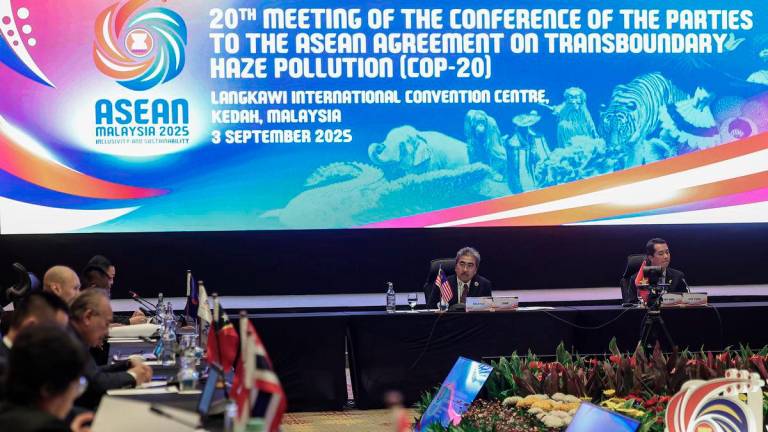 Acting Minister of Natural Resources and Environmental Sustainability, Datuk Seri Johari Abdul Ghani (left), with Deputy Director General of the Vietnam Forestry Department under the Ministry of Agriculture and Environment, Dr Bui Chinh Nghia (right), during the 20th Meeting of the Conference of the Parties to the ASEAN Agreement on Transboundary Haze Pollution (COP-20), at the Langkawi International Convention Centre (LICC) yesterday. - BERNAMA