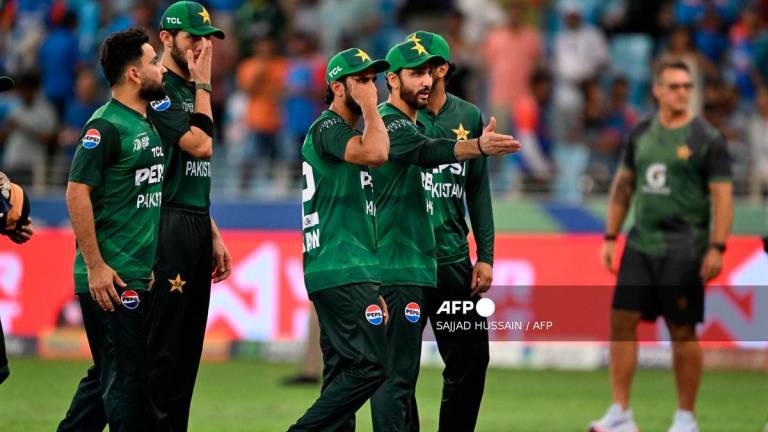 Pakistan’s players walk back to the pavilion at the end of the Asia Cup 2025 Twenty20 international cricket match against India at the Dubai International Stadium in Dubai on September 14, 2025. (Photo by SAJJAD HUSSAIN / AFP)
