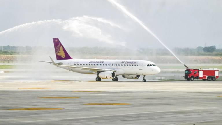 An Air Cambodia A320 given a water cannon welcome upon its arrival at the newly built Techo International Airport yesterday. – AFPPIX