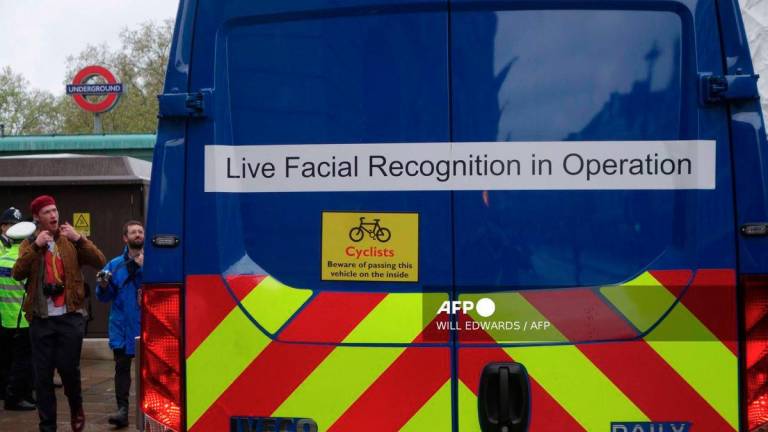 A van being used by the metropolitan police as part of their Facial Recognition operation is pictured close to the route of the 'King's Procession', a two kilometres stretch from Buckingham Palace to Westminster Abbey, in central London, on May 6, 2023. - AFP