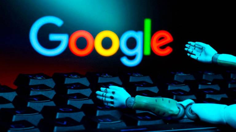 FILEpix The Google logo, a keyboard, and robot hands are seen in this illustration taken January 27, 2025. REUTERS
