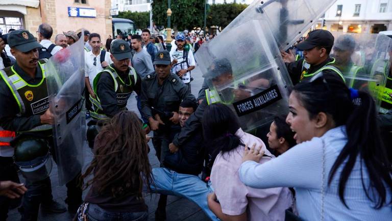 Members of the security forces detain a protester as others scuffle during a youth-led demonstration in Rabat on September 29, 2025, calling for reforms in the public health and education sectors. - Abdel Majid BZIOUAT / AFP