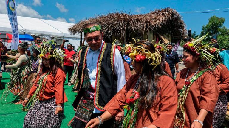Perdana Menteri Datuk Seri Anwar Ibrahim learning dance steps from Orang Asli performers during the national-level 2025 National Unity Week (SMP) celebrations, yesterday. - Bernama pic