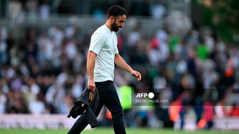 Manchester United's Portuguese head coach Ruben Amorim walks on the pitch after the English Premier League football match between Fulham and Manchester United at Craven Cottage in London on August 24, 2025.- AFP