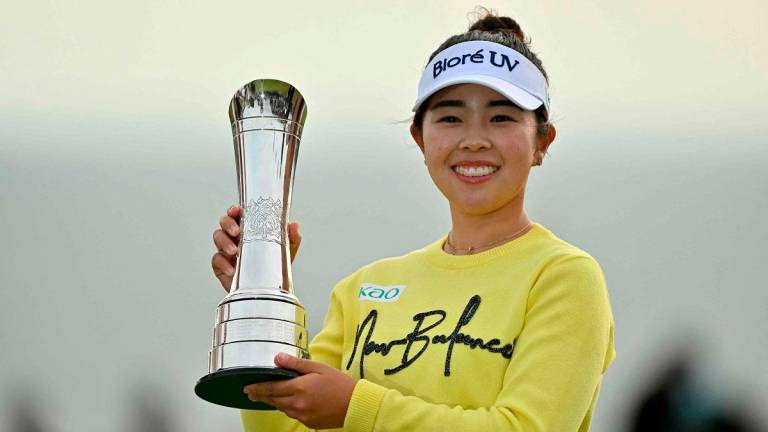 Japan’s Miyu Yamashita lifts the trophy after winning on the final day of the Women’s British Open Golf Championship, at Royal Porthcawl in south Wales on August 3, 2025. - Glyn KIRK / AFP