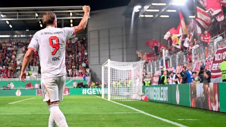 Bayern Munich's English forward #09 Harry Kane (R) celebrates scoring the 2-3 goal with his teammates in front of their fans during the German Cup (DFB Pokal) first round football match between SV Wehen Wiesbaden and FC Bayern Munich in Wiesbaden, western Germany on August 27, 2025. - AFPPIX