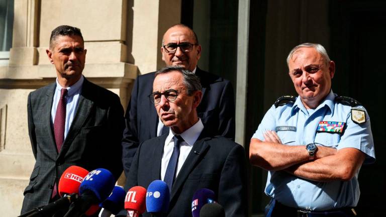 France’s Minister of the Interior Bruno Retailleau (C), flanked by Paris Police prefect Laurent Nunez (rear C), speaks to the press following a meeting with prefects at the Ministry of Interior, in Paris, on September 9, 2025. (Photo by ALAIN JOCARD / AFP)