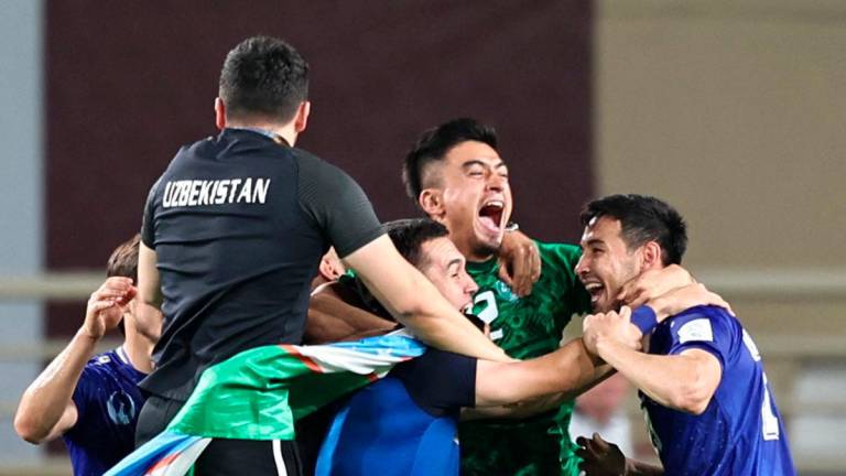 Uzbekistan’s players celebrate after their 2026 FIFA World Cup Asian Qualifier football match against the United Arab Emirates ended in a draw, qualifying them for the World Cup for the first time, at Al-Nahyan Stadium in Abu Dhabi on June 5, 2025. AFP
