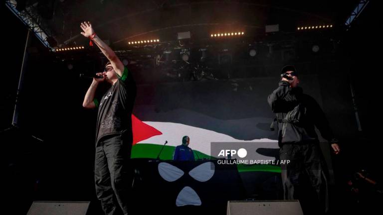 Northern Ireland hip-hop band Kneecap perform on stage in front of a Palestinian flag on a screen during a concert at the Rock en Seine music festival in Saint-Cloud, near Paris, on August 24, 2025. - AFP