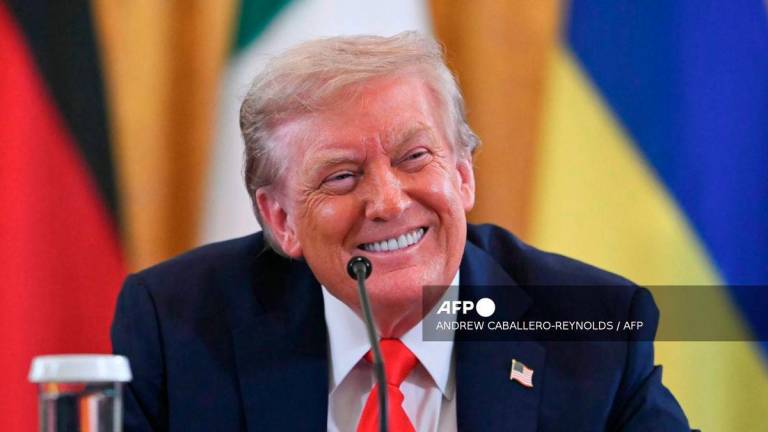 US President Donald Trump smiles during a meeting with Ukrainian President Volodymyr Zelensky and European leaders in the East Room of the White House in Washington, DC, on August 18, 2025. - AFP