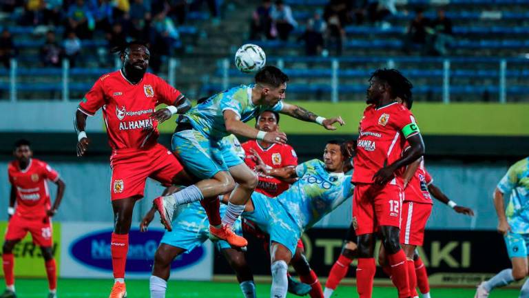 Penang player Danilo Sipovac (centre) is challenged by Kelantan players during the Super League match at Stadium Bandaraya last night. At that point, Kelantan were leading Penang 1-0. – BERNAMA